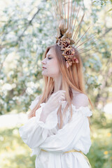 Naklejka premium Bride of the sun in white in the apple trees