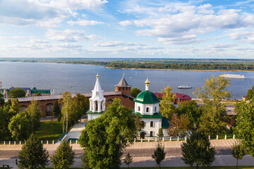 Fototapeta na wymiar View of the Volga River, the Temple of St. Simeon the Stylite in the Kremlin and ships sailing along the Volga. Nizhny Novgorod, Russia