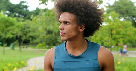 african man thinking contemplative at park