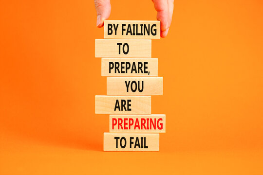 Preparing symbol. Concept words By failing to prepare you are preparing to fail on wooden blocks on a beautiful orange background. Businessman hand. Business motivational and preparing concept.