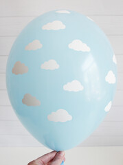 blue latex balloon with clouds on a white background