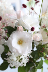 Bouquet with white roses and hydrangeas in the interior