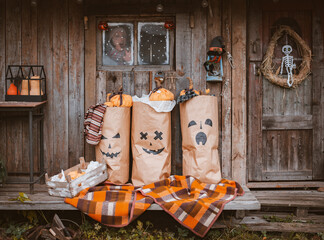 Photo zone for Halloween with festive handmade paraphernalia. Kraft paper bags painted with Jack...