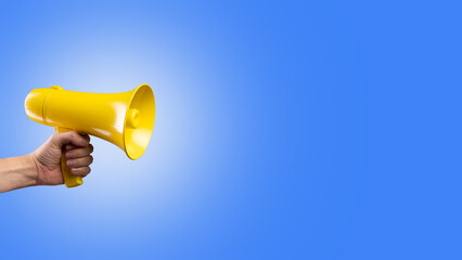 Yellow megaphone on a sky blue background. false information, rumors, fakes, elections, debates, advertising, yellow press. There is free space to insert. Banner, advertising.