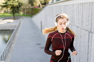 healthy happy woman jogging running outdoor listening music