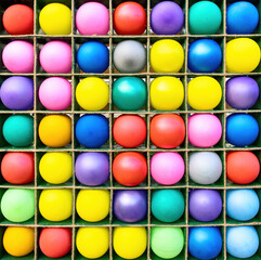 Colorful balloons in the square wooden shelves for game purposes	