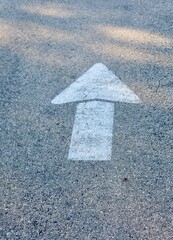 The white arrow on the pavement.