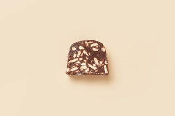 Traditional portuguese dessert Salame de Chocolate on beige background in minimal style. Restaurant bakery menu