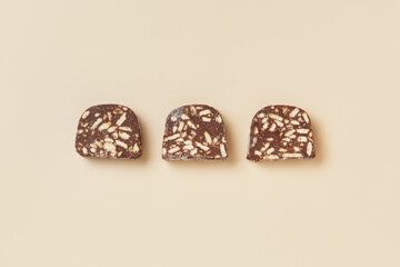 Traditional portuguese dessert Salame de Chocolate on beige background in minimal style. Restaurant bakery menu