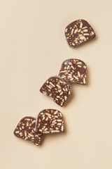 Traditional portuguese dessert Salame de Chocolate on beige background in minimal style. Restaurant bakery menu