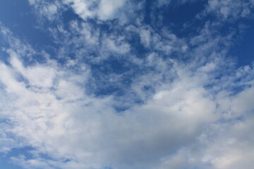A large swirl of clouds on a dark blue sky. Background, wallpaper for designers