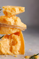 the tower of semi-hard cheese is beautifully tied with a rope.