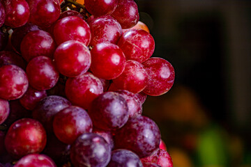 group of grapes. grapes for sale in the market. market place in latin america. sweet fruits. red grapes.