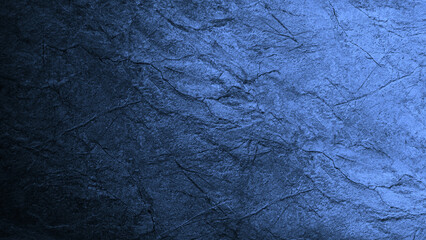 Blue stone granite texture with cracks. Toned rough rock surface. Close-up. Color gradient. Dark light. Background with space for design. Wallpaper, backdrop.