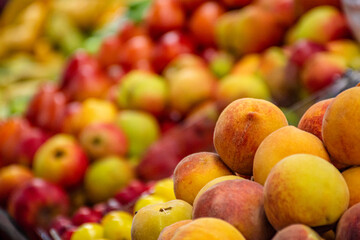peaches. sweet fruit for sale in the market. tropical fruits. fruit for sale. peaches at the market stall. 