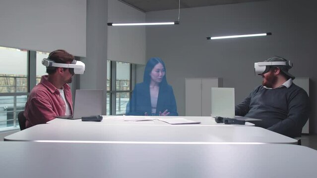Asian businesswoman join virtual meeting with colleagues in augmented reality goggles