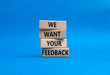 We want your feedback symbol. Wooden blocks with words We want your feedback. Beautiful blue background. We want your feedback concept. Copy space.