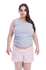 A sad overweight woman in shorts and a gray t-shirt is standing. Obesity and fast food. Isolated on...