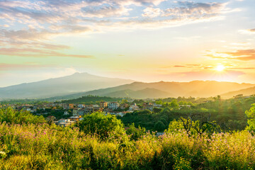 Obraz premium picturesque highland landscape with amazing view from hill with golden grass and green bushes