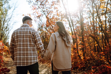 Fototapeta premium Stylish couple walking and enjoying autumn weather. People, lifestyle, relaxation and vacations concept. Autumn Fashion, style concept.