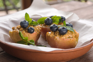 Baked in an apple oven with cottage cheese, cinnamon and mint on parchment paper. Diet food. Autumn dish. Traditions of Ukrainian and German cuisine.