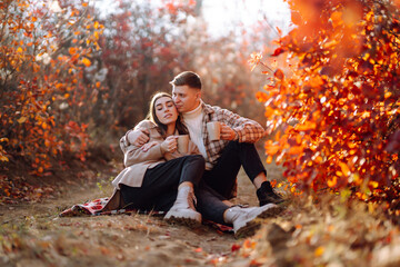 Stylish couple walking and enjoying autumn weather. People, lifestyle, relaxation and vacations concept. Autumn Fashion, style concept.