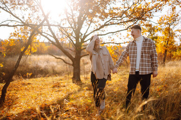 Stylish couple walking and enjoying autumn weather. People, lifestyle, relaxation and vacations concept. Autumn Fashion, style concept.