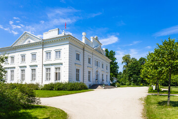 Fototapeta na wymiar Uzutrakis manor. Colonnaded mansion set in landscaped gardens. Trakai, Lithuania, 2 July 2022