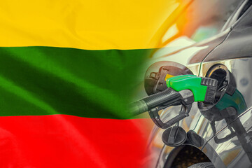 Car with a fuel injector on Lithuania flag background. Record prices fuel for population. Gasoline...