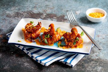 knock out fried shrimp with sauce served in a dish isolated on napkin side view of fastfood