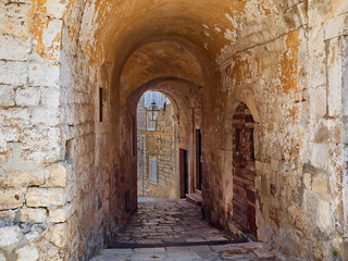 Fototapeta na wymiar Ancient stone archway in Dubrovnik Old Town. Croatia, Europe