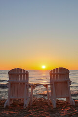 Adirondack chairs at summer sunrise