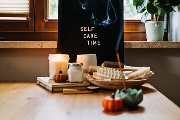 Self-care, Wellness in autumn, winter cold season. Letter board text Self Care Time, aroma sticks,...