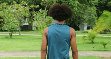 Back of african black man walking at park outdoors