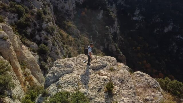 Video of a hiker on the Pico de Mill&agrave; (1,025 m) with breathtaking views and vertiginous cliffs on the splendid balcony over the Congost de Fet. In autumn season in Canelles reservoir. Catalonia