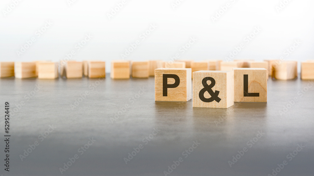Aufkleber three wooden blocks with letters p and l - profit and loss - with focus to the single cube in the fo