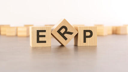 word ERP is made of wooden blocks on gray background