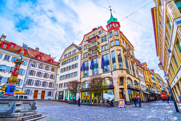 Kapellplatz square with stunning historical buildings and colorful fountain in Lucerne, Switzerland
