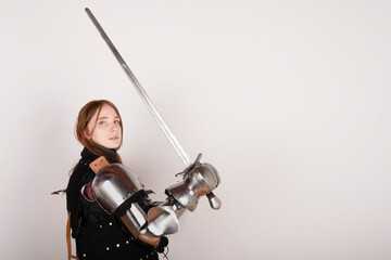 Fototapeta na wymiar History of the Middle Ages. Portrait of a beautiful medieval female knight in armour on a white background..
