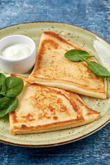 tasty breakfast with pancakes and herbs