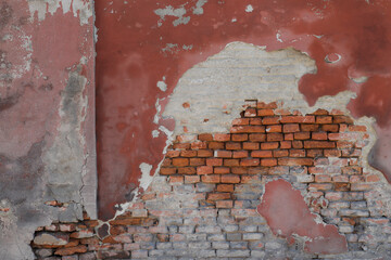 Old red brick wall with peeling paint, red stone wall as surface brickwork