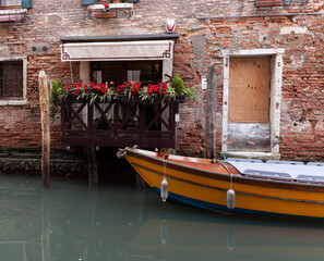 Fototapeta na wymiar Typical wooden boat in the Venice canal
