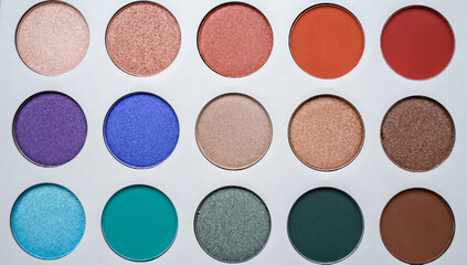 Selective focus of eyeshadow palette with various colors in pearly and matte closeup