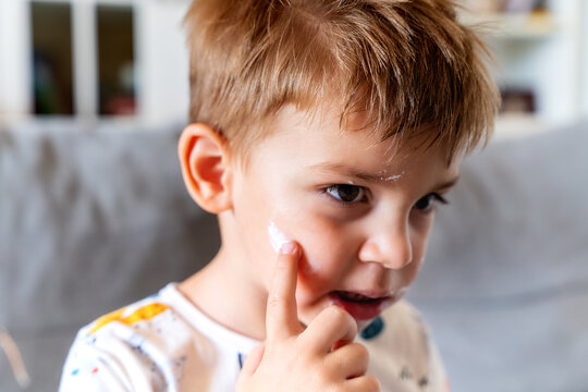 Little Boy Applying Face Cream
