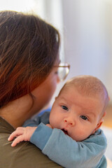 Pretty woman holding a newborn baby in her arms
