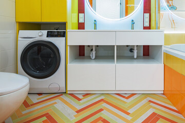 Washing machine and sink cupboard in the bathroom.