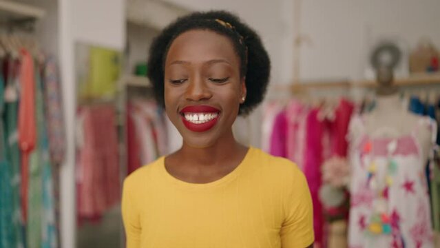 African american woman customer holding shopping bags having video call at clothing store