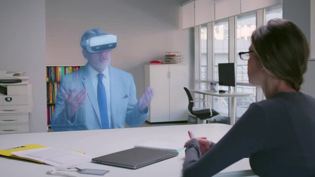 Hologram of businessman in vr goggles have virtual meeting with female manager