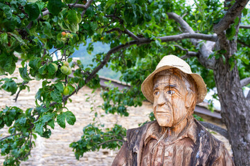 Handcrafted wooden sculpture in a village in the Occitan region (Ligurian Alps, Realdo, Imperia).  Is a region between France and Italy, where the ancient medieval French is spoken, called Langue d'Oc