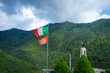 Italian and Occitan flags waving in a village in the Ligurian Alps (Realdo, Imperia). Occitania is a region between France and Italy, where an ancient medieval French is spoken, called "Langue d'Oc".